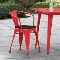 Lancaster Table & Seating Alloy Series Red Stackable Metal Indoor / Outdoor Industrial Cafe Arm Chair with Black Fabric Magnetic Cushion