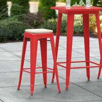 Lancaster Table & Seating Alloy Series Red Stackable Metal Indoor / Outdoor Industrial Barstool with Tan Fabric Magnetic Cushion