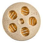 A circular gold pasta die with holes in it.