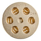 A circular gold metal object with holes in it.