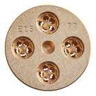 A circular gold metal disc with holes in it.