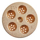 A circular gold metal surface with a circular center with small holes in it.