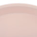 A close up of a round light peach Cambro tray.