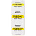 A roll of white National Checking Company labels with yellow text that says "Tuesday"