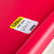 A red surface with a National Checking Company Tuesday food labeling sticker on it.