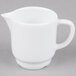 A white Arcoroc stackable porcelain creamer with a handle.