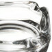 A close up of a Libbey clear glass square ashtray with a small hole in the middle.