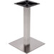 A brushed stainless steel square table base with black screws.