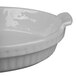 A natural cast aluminum shallow oval casserole dish with a handle.