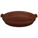 A maroon cast aluminum shallow oval casserole dish with handles.