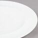 A close up of an Arcoroc Vintage white salad plate with a white rim.