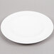 An Arcoroc white porcelain salad plate with a white rim.