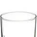 A close up of a Libbey clear drinking tumbler with a circular edge.