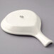 A Tuxton eggshell white china fry pan server with a handle.