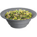 A Tablecraft wide rim salad bowl filled with lettuce, celery, and purple and green vegetables.