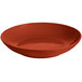 A red Tablecraft cast aluminum pasta bowl with a white background.