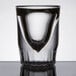 An Anchor Hocking fluted shot glass with a curved edge.