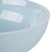 A close up of a blue melamine bowl with a white rim.