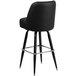 A Flash Furniture black metal barstool with a padded swivel seat.
