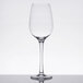 A clear Thunder Group plastic wine glass on a reflective surface.