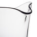 A clear polycarbonate pitcher with a curved handle.