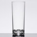 A clear Thunder Group plastic beverage glass with a small amount of milk in it.