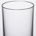 A close up of a clear plastic Thunder Group Classic Beverage Glass with a white background.