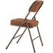 A National Public Seating brown metal folding chair with a brown fabric cushion.