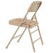 A National Public Seating beige metal folding chair with a French beige vinyl padded seat.