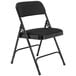 A National Public Seating black metal folding chair with a black fabric padded seat and back.
