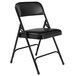 A National Public Seating black metal folding chair with a black padded seat.