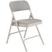 A gray National Public Seating metal folding chair with a gray cushion.