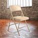 National Public Seating 1201 Beige Metal Folding Chair with 1 1/4" French Beige Vinyl Padded Seat Main Thumbnail 1