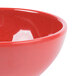 A close-up of a red bowl with speckles.