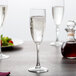 An Arcoroc Rutherford champagne flute filled with champagne sits on a table