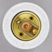 A white round socket with gold and silver screws.