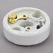 A white round Nemco socket with gold and silver screws.