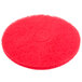 A red circular Scrubble floor pad with a circle in the middle.