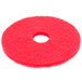 A red circular Scrubble by ACS buffing pad with a hole in the middle.