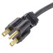 A black electrical cord with two gold plugs.