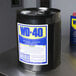 A black barrel of WD-40 Heavy Duty Lubricant with a white label on it.