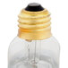A Nemco light bulb with a clear lens, gold cap, and black base.