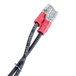 A white cable with a red connector on the end.