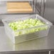 A clear Rubbermaid colander tray with lettuce inside.