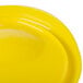 A yellow Rubbermaid food storage container lid.