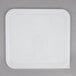 A white square Rubbermaid lid on a gray surface.