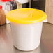 A yellow Rubbermaid food storage container with a yellow lid.