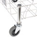 A Rubbermaid stainless steel Slim Jim dolly with wheels.