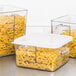 A Rubbermaid clear square polycarbonate food storage container filled with pasta on a counter.