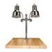A Hanson Heat Lamps dual lamp chrome carving station on a wooden surface.